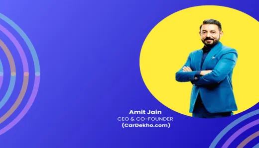 Amit Jain, blue-suited with arms crossed, embodies CarDekho's leadership evolution; data-light yet engaging.